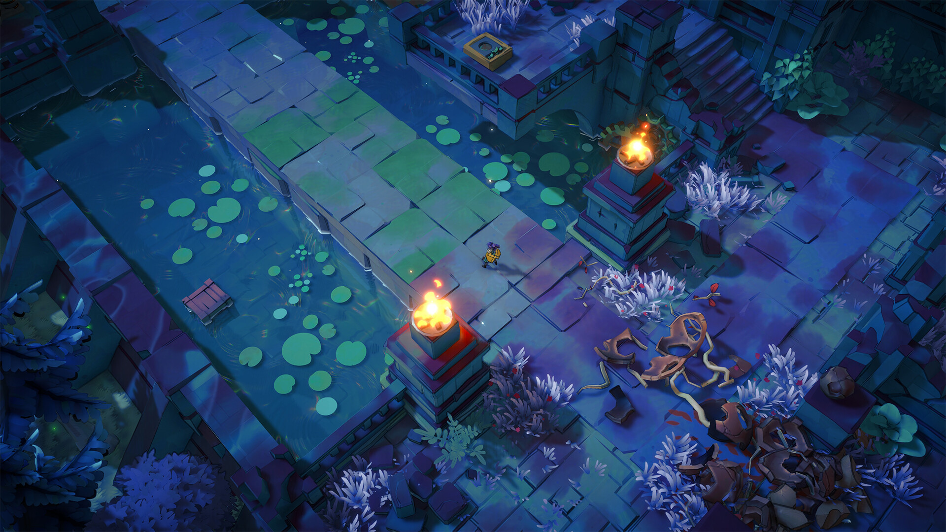 Sonia crosses a stone bridge beside water, vegetation and lit structures.